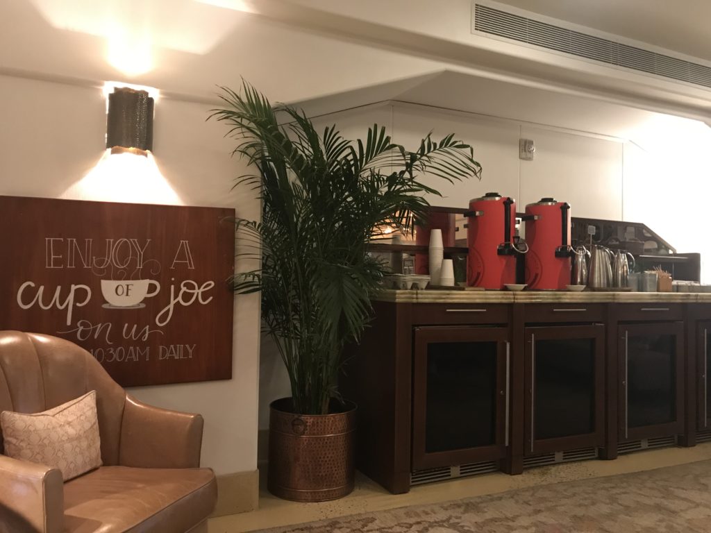 a coffee bar with a plant in front of it