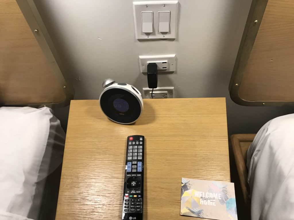 a remote control and a speaker on a table