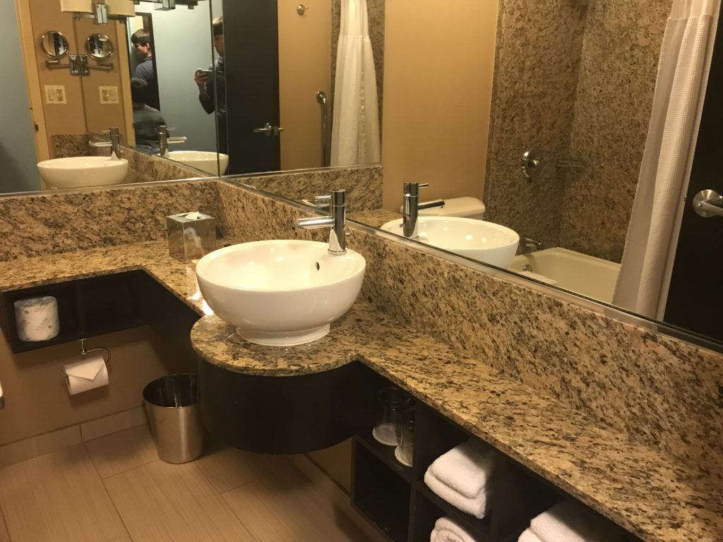 a bathroom with a marble countertop and sink
