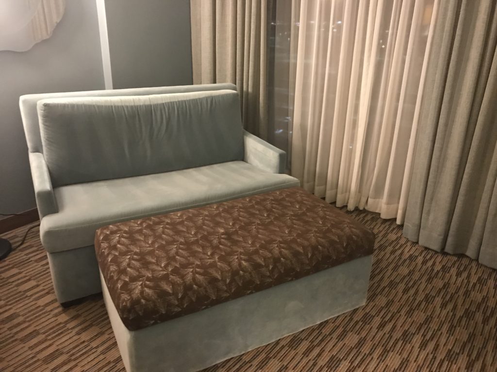 a couch and ottoman in a room