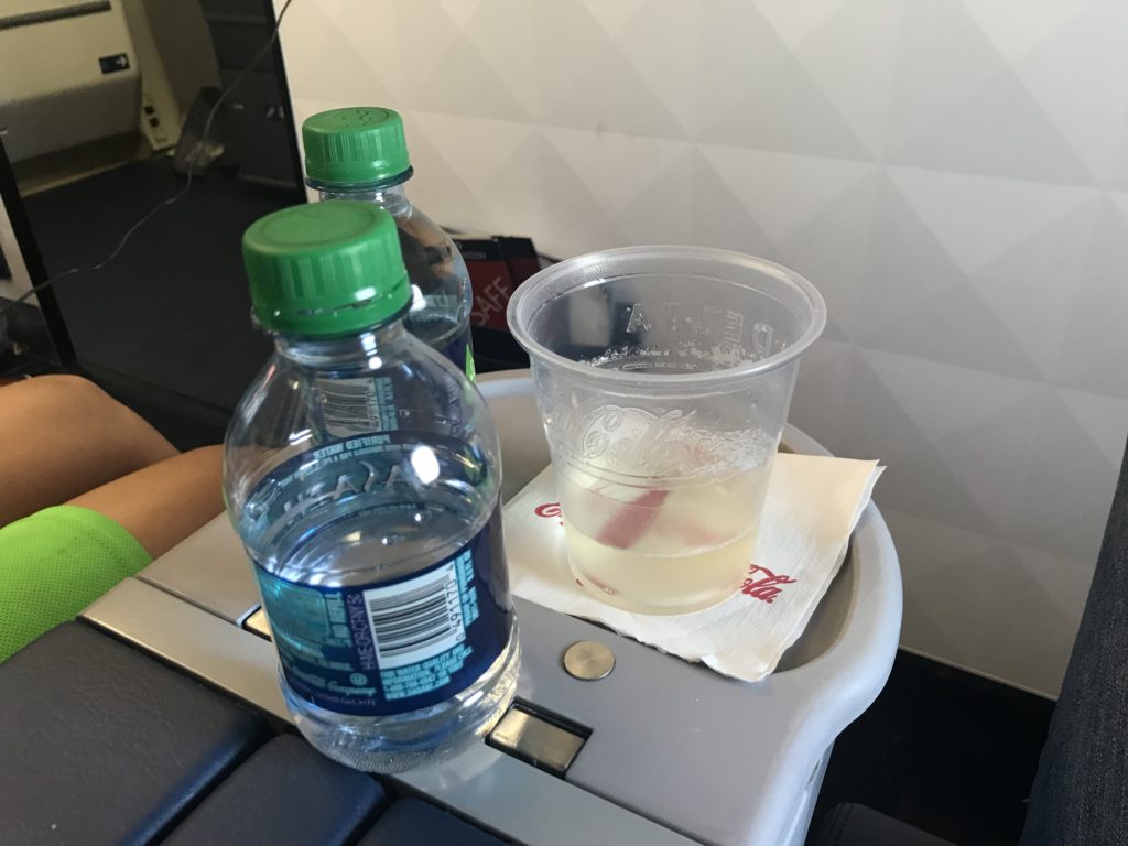 a plastic bottle and a cup on a tray
