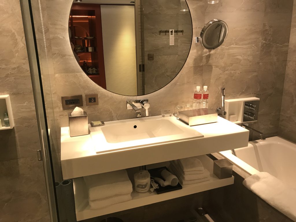 a bathroom with a round mirror
