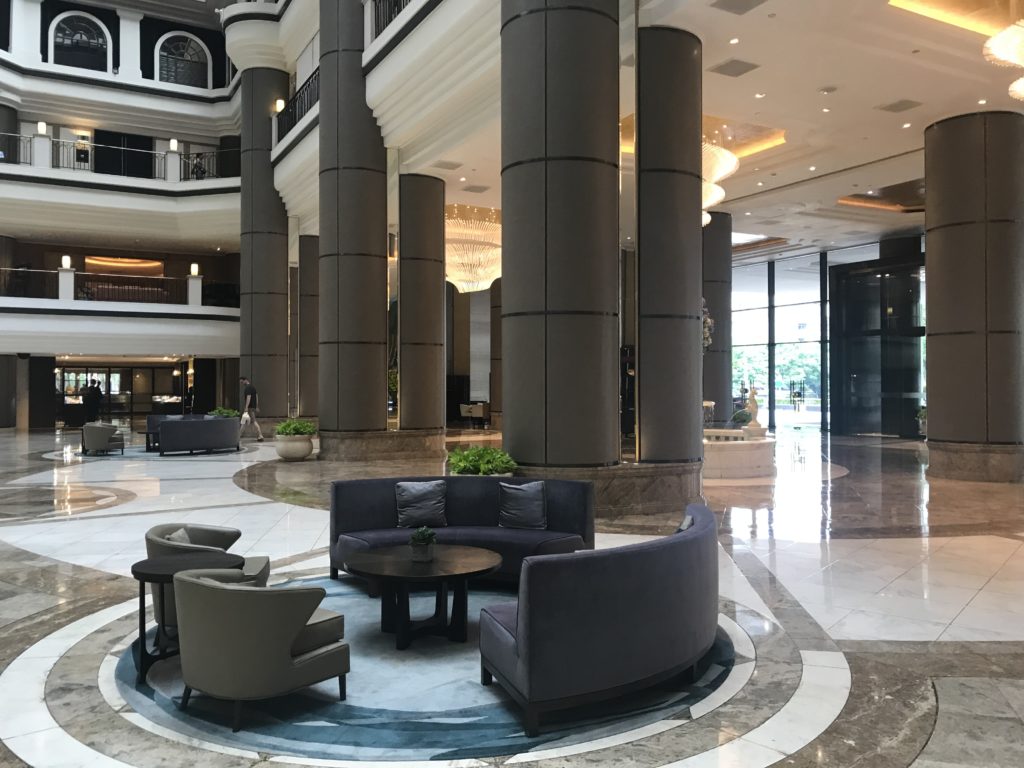 a lobby with a round table and chairs