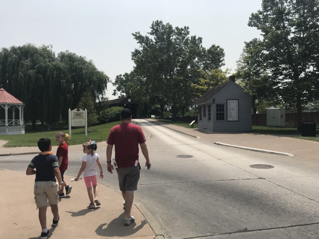 a group of kids walking down a street