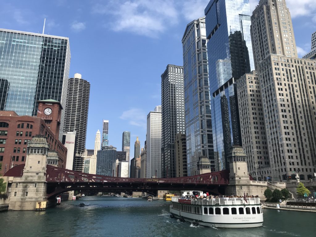 a boat on a river with a bridge over it