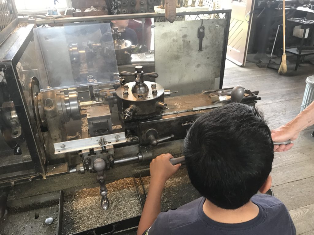 a boy working on a machine
