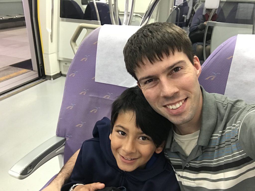 a man and boy sitting in a train