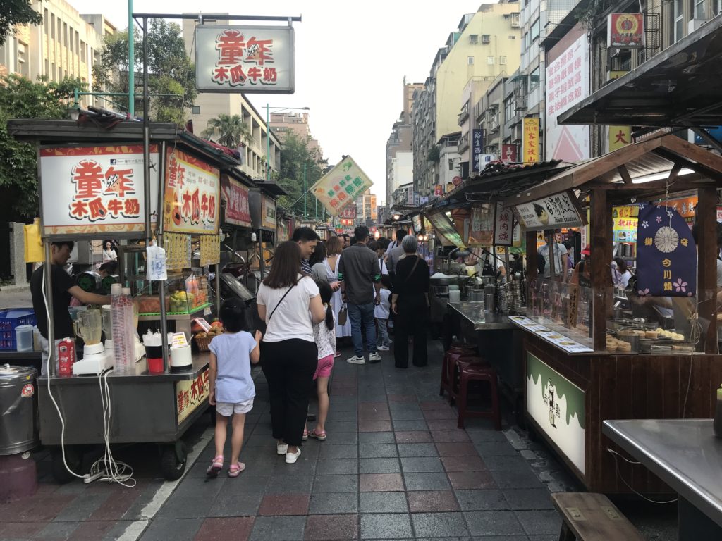 people walking through a street market