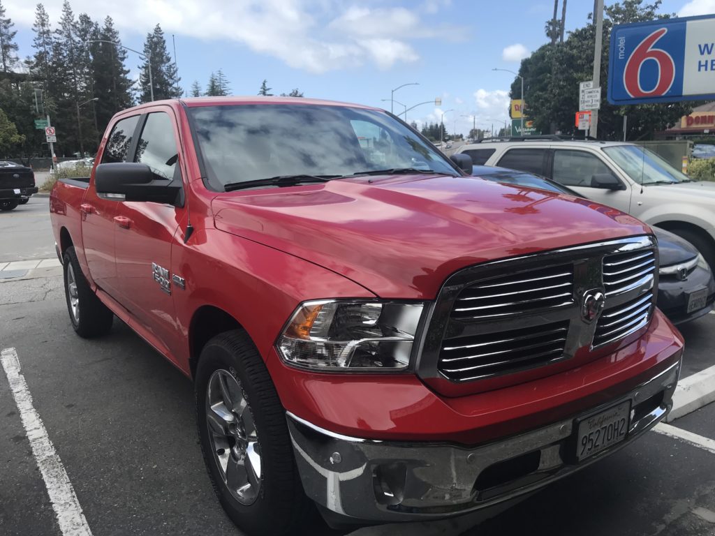 a red truck parked in a parking lot