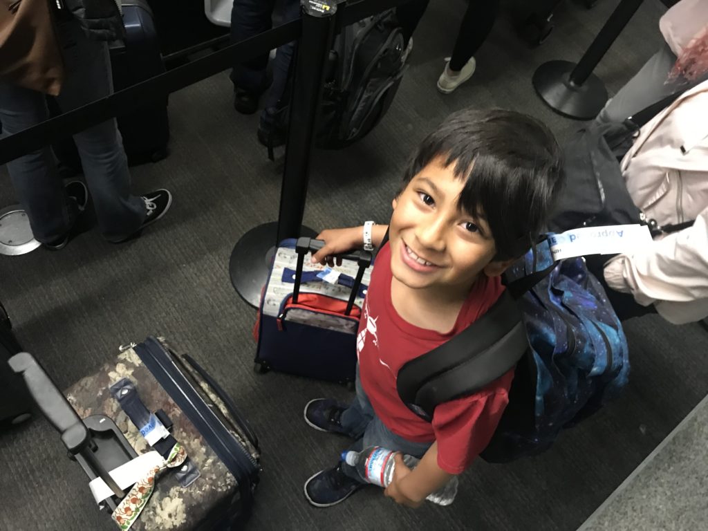a boy with a backpack and luggage