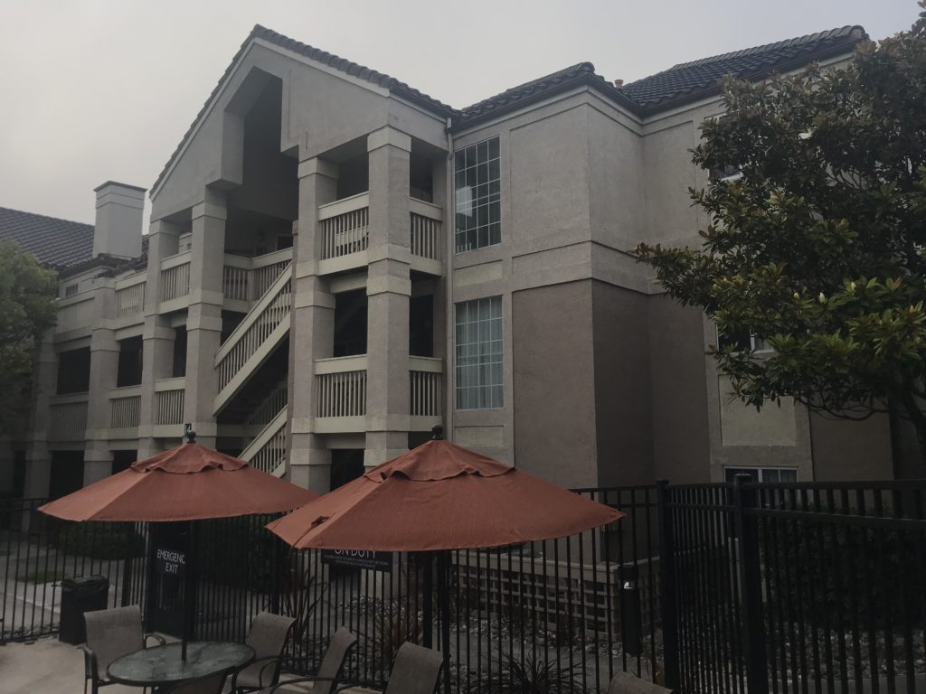 a building with umbrellas and chairs