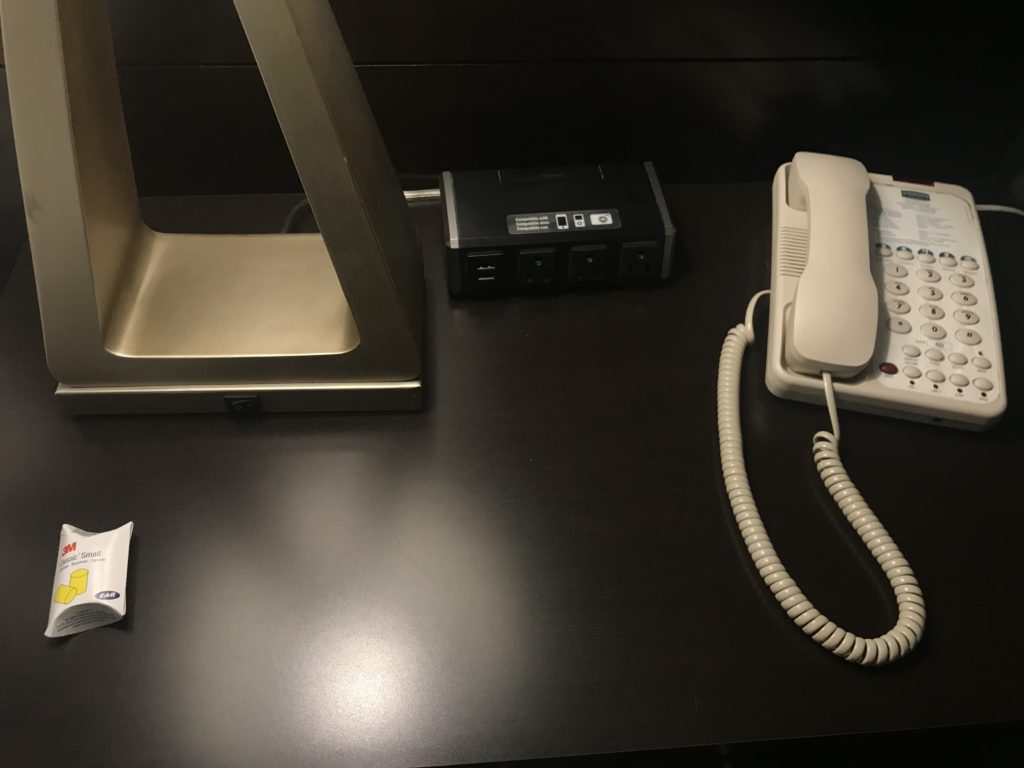 a telephone and a lamp on a desk