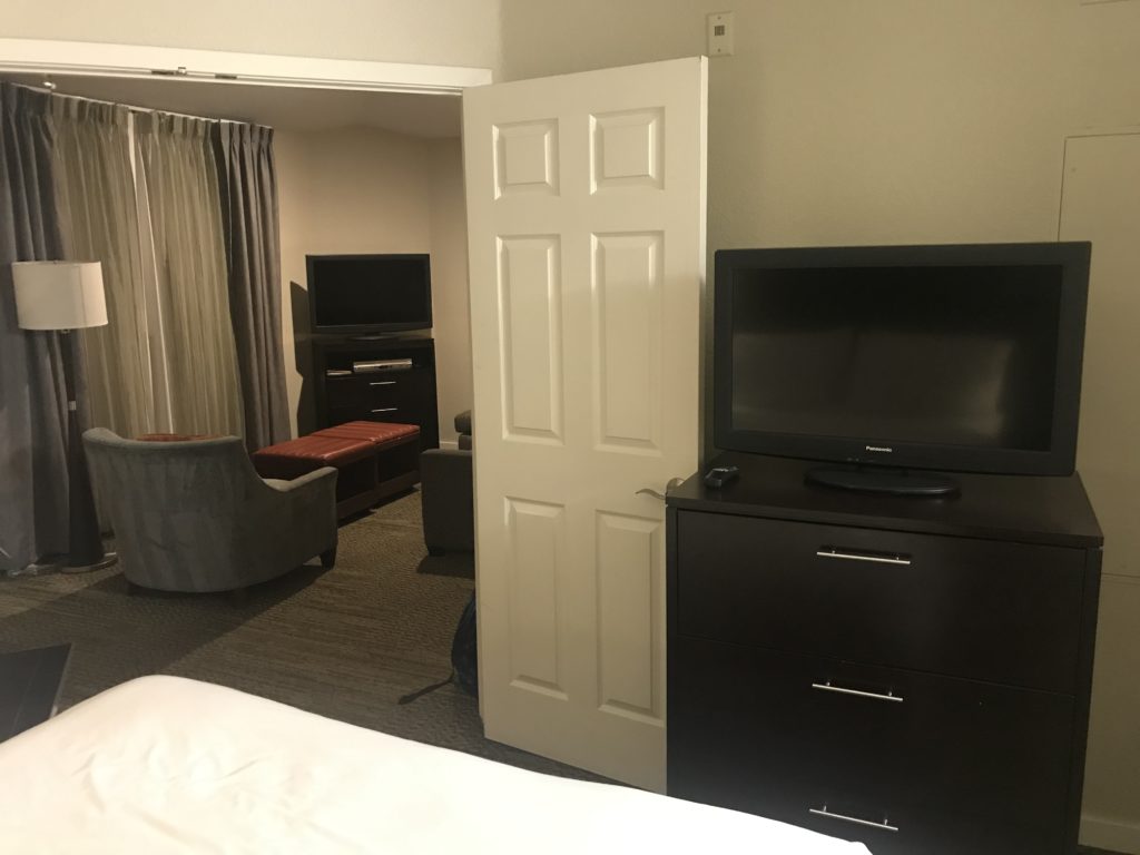 a room with a tv and a door
