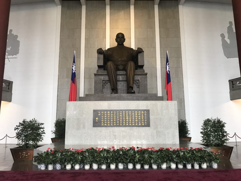 a statue of a man sitting on a chair