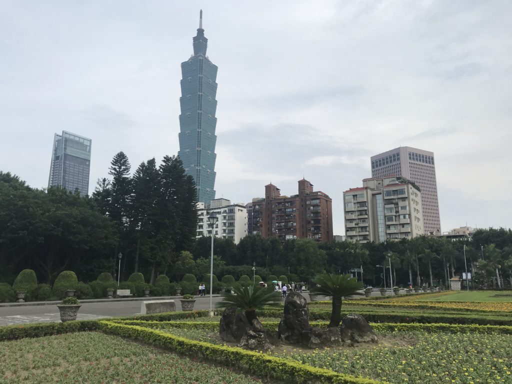 a park with a tall building in the background