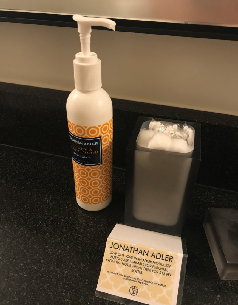 a bottle of soap next to a box of cotton swabs