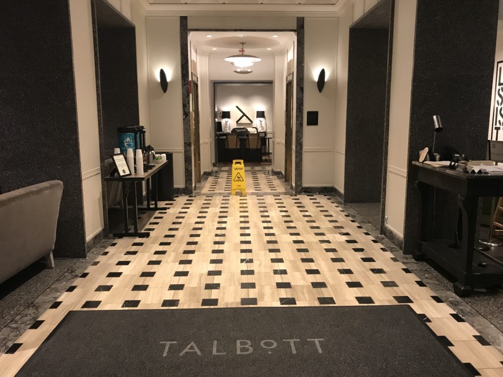 a hallway with a black and white checkered floor