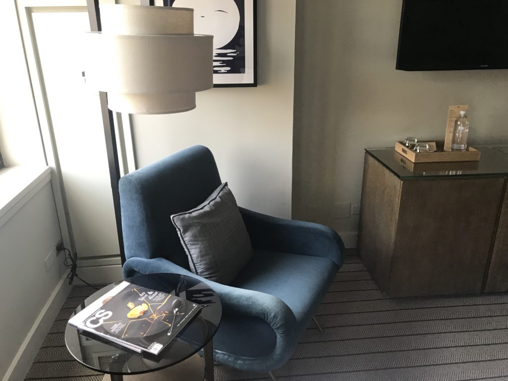 a blue chair next to a table