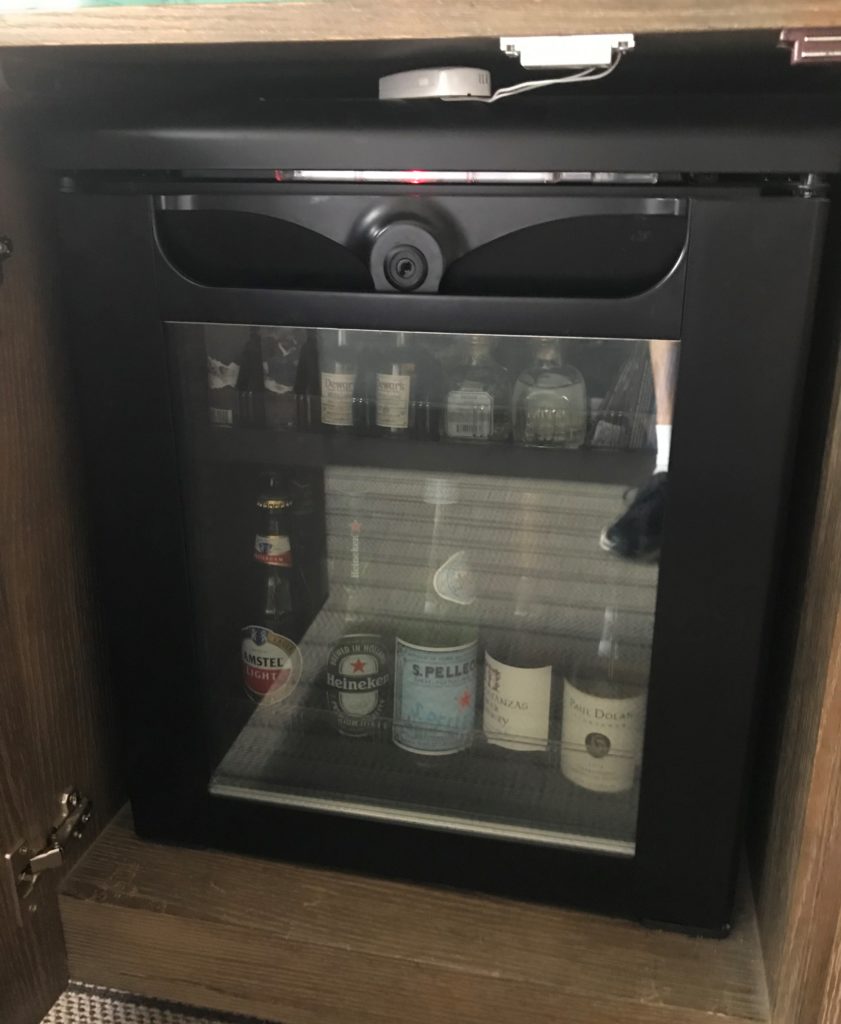 a mini fridge with a glass door