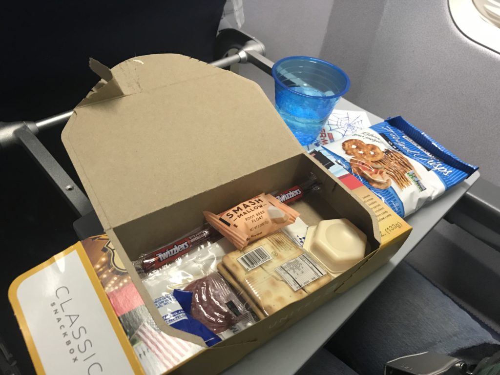 a box of snacks and a cup on a table