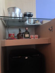 a shelf with bottles and other objects on it
