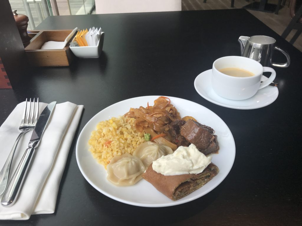 a plate of food and a cup of coffee