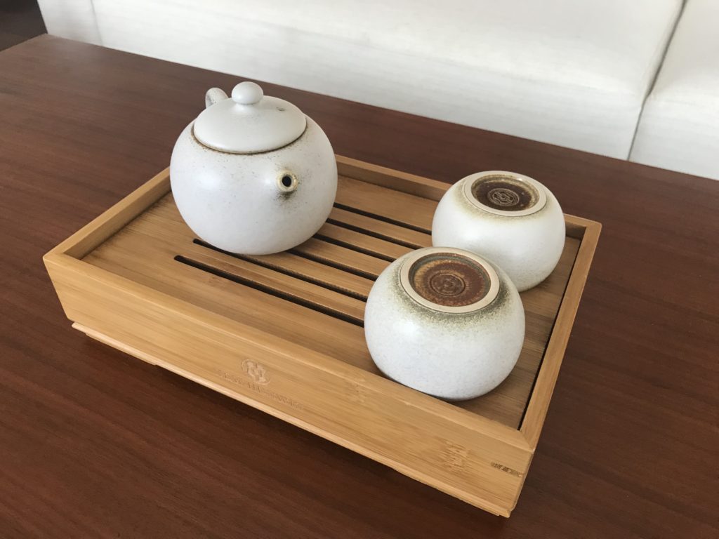 a tea set on a wooden tray