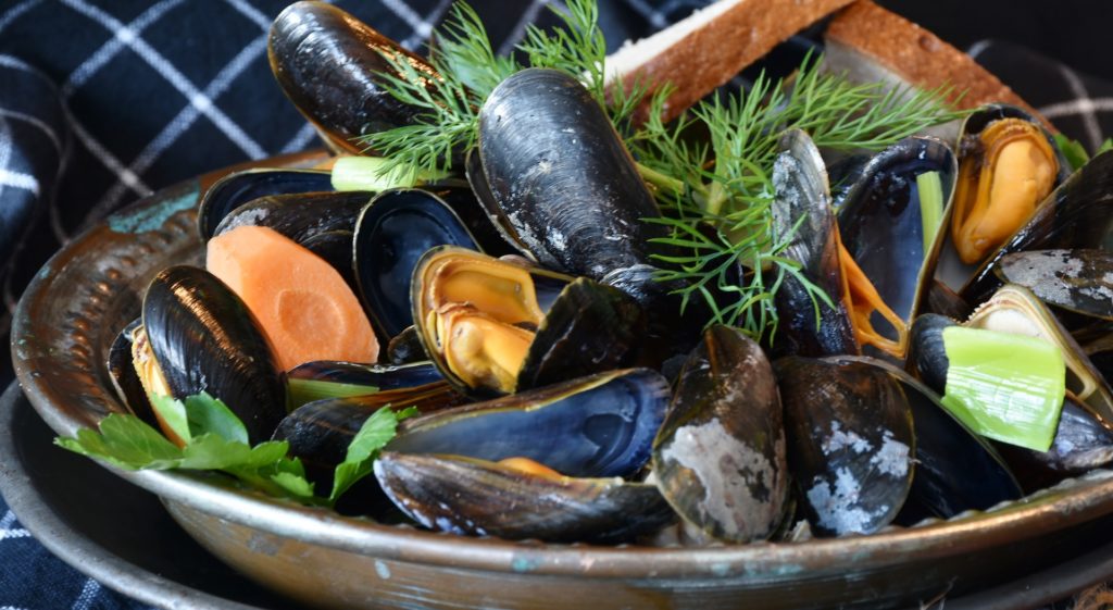 a bowl of mussels and carrots