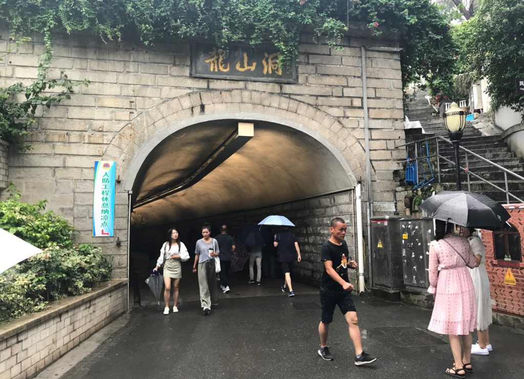 people walking under a tunnel