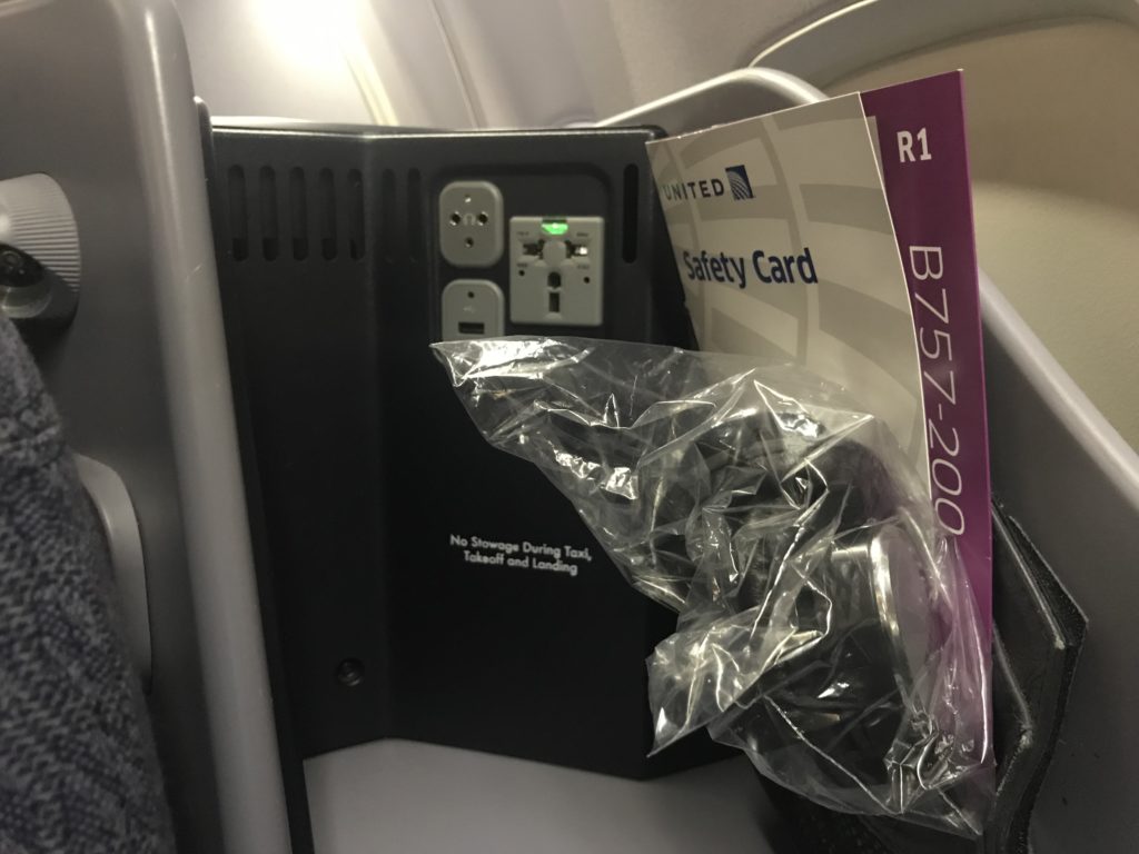 a safety card and a plastic bag on an airplane