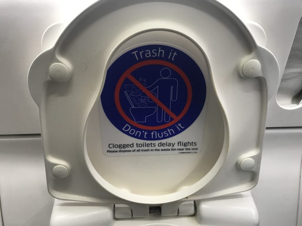 a toilet lid with a sticker