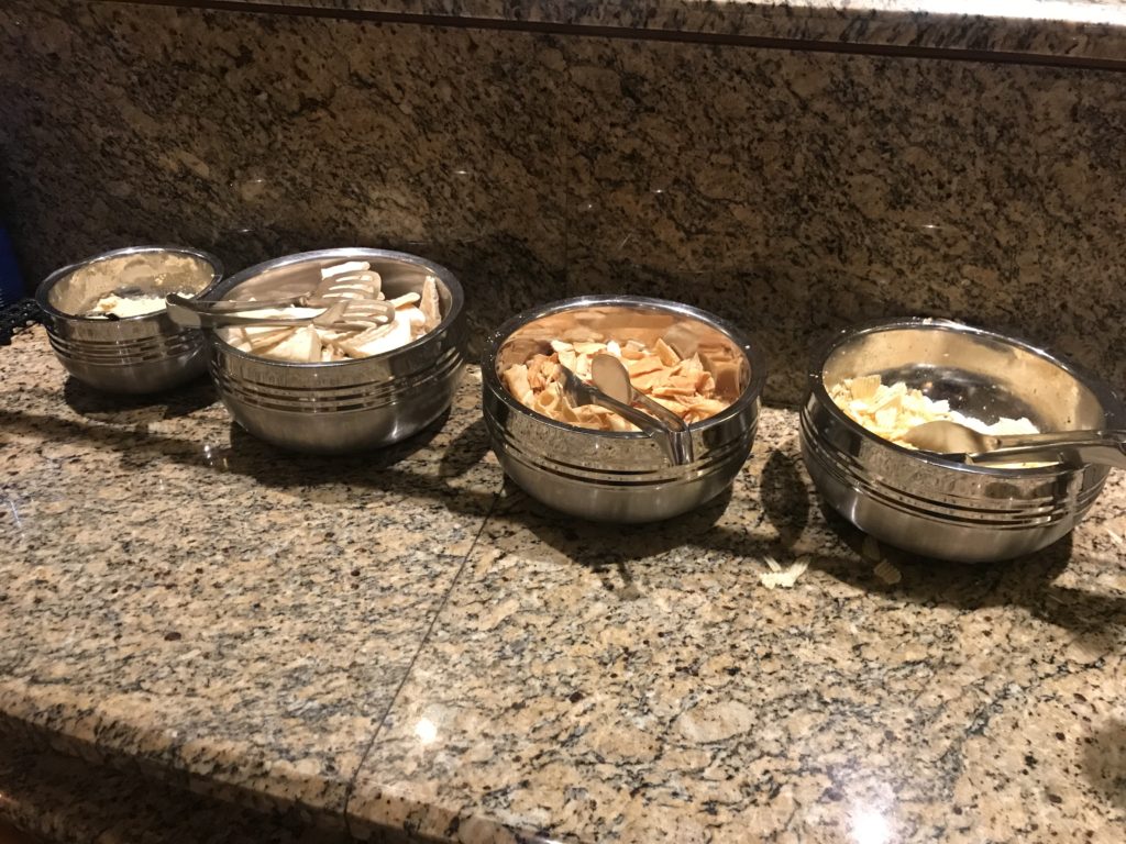 a row of bowls with food in them