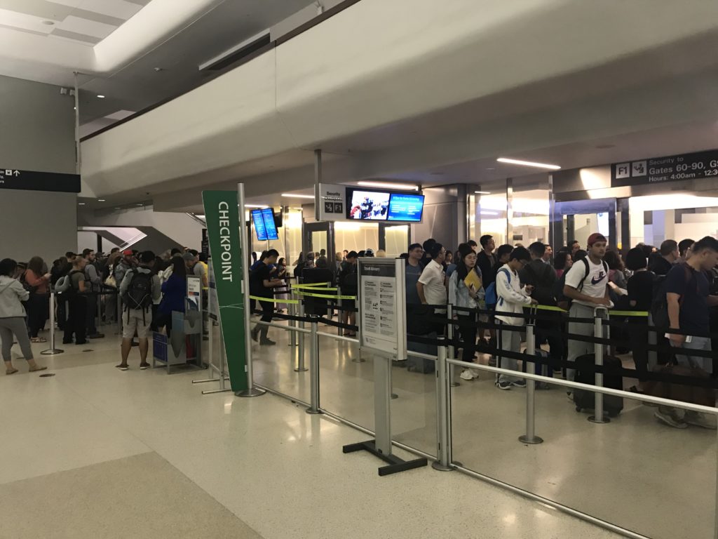 a group of people in a line at an airport