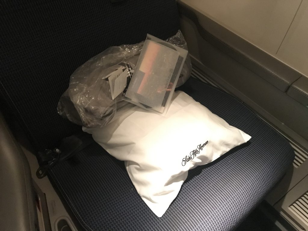a white pillow and a plastic bag on a seat