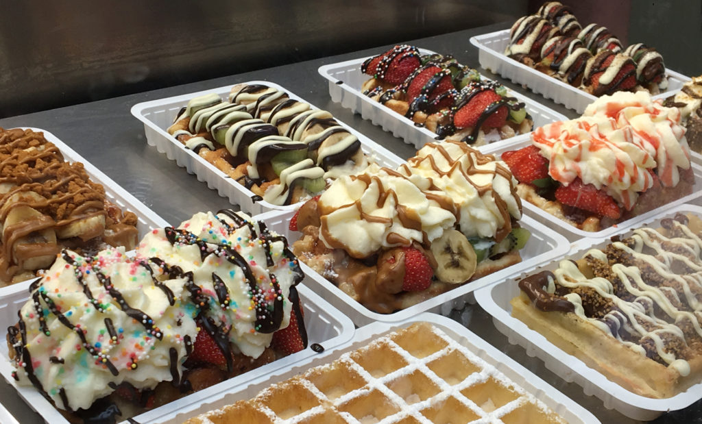 a group of waffles with toppings