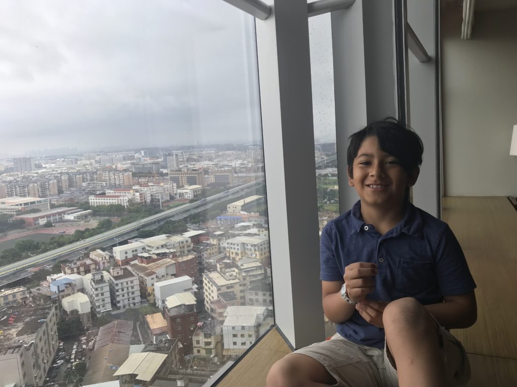 a boy sitting on a window ledge