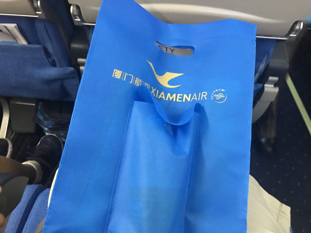 a blue bag on a plane