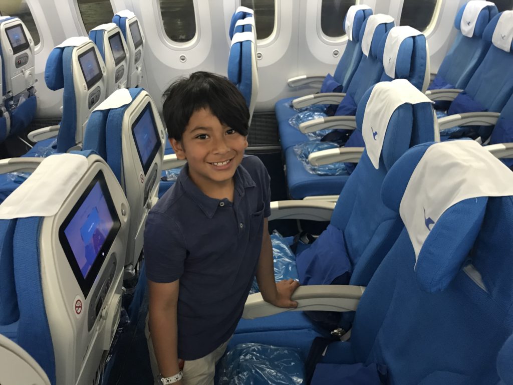 a boy standing in an airplane