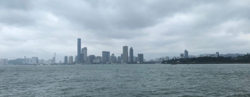 a city skyline with water and clouds