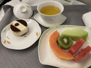 a plate of fruit and a cup of tea