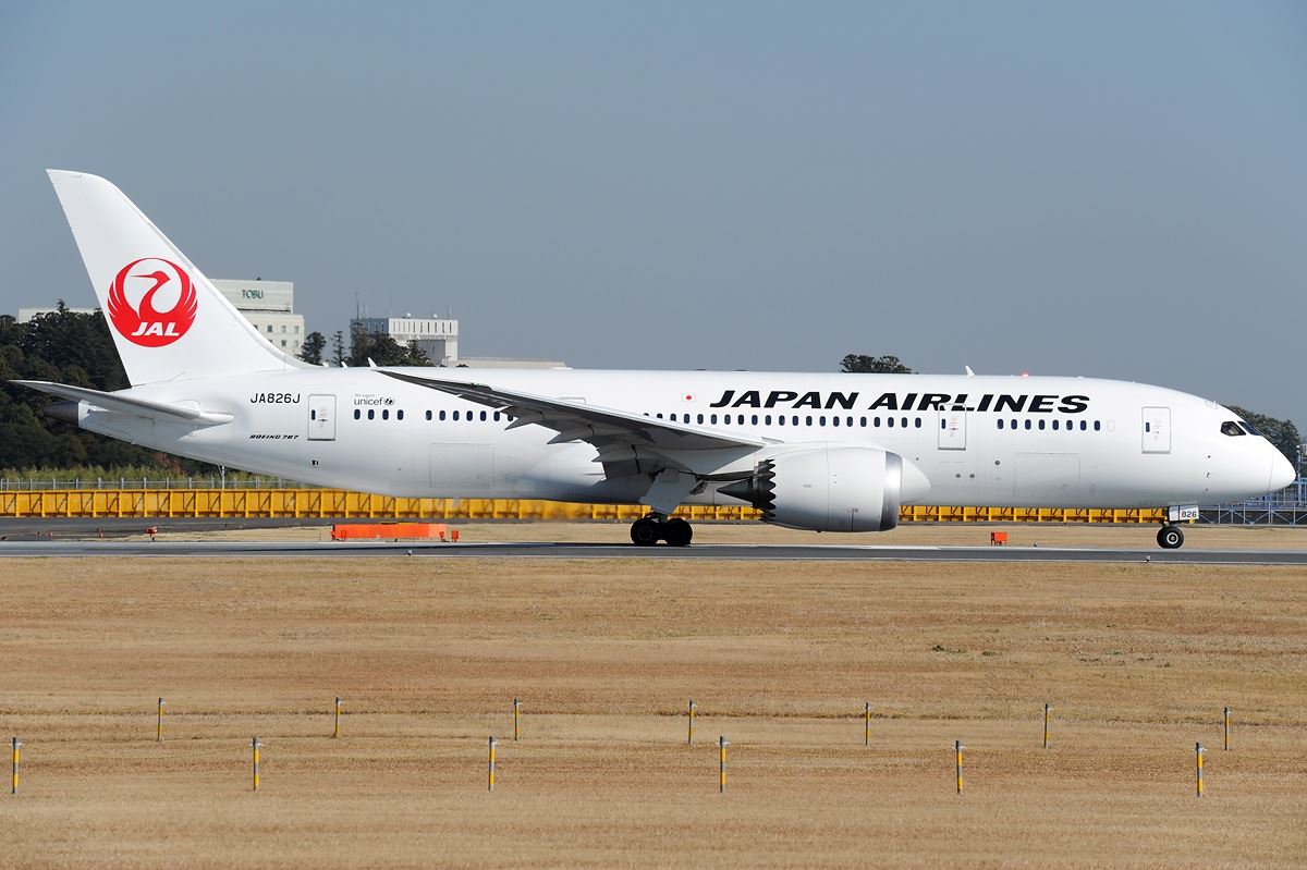 a white airplane on a runway