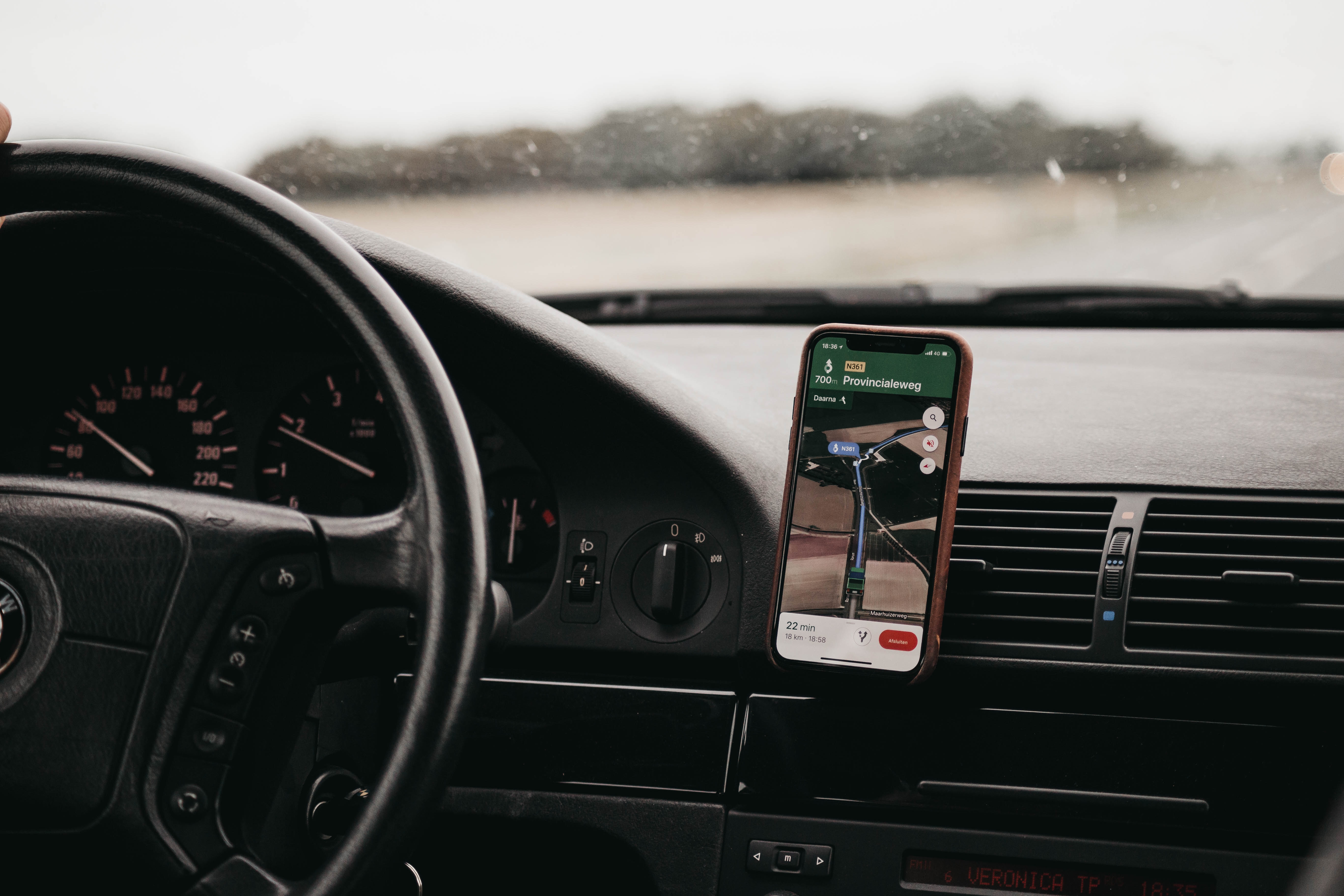 a phone on the dashboard of a car