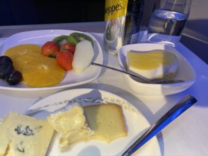 a plate of fruit and cheese on a table