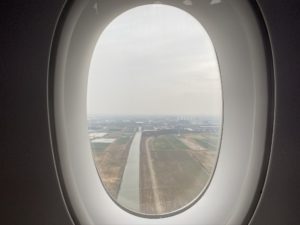 an airplane window with a view of a field and land