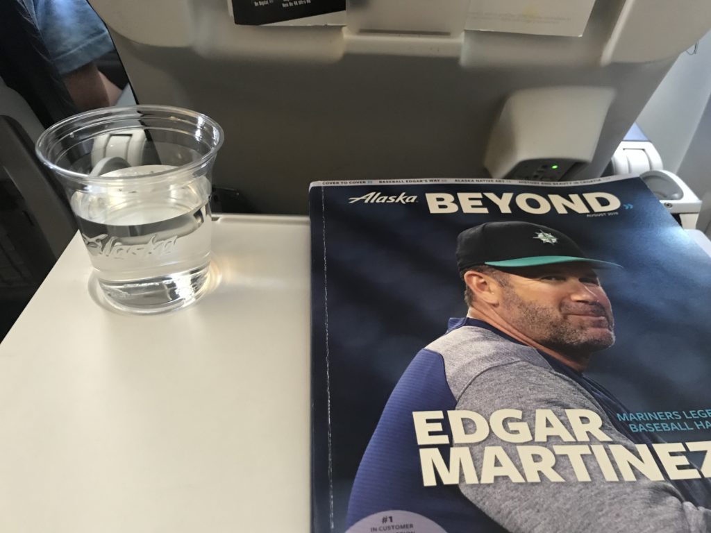 a magazine and a glass of water on a table