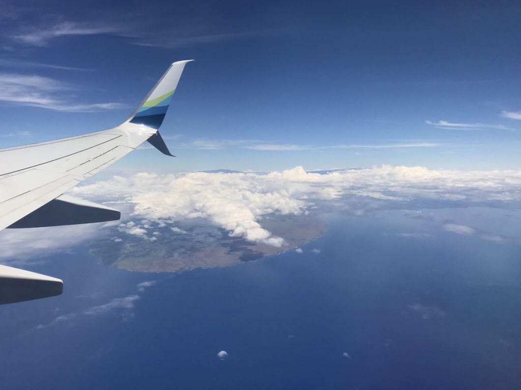 an airplane wing above the clouds