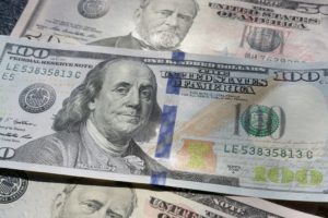 a close-up of several hundred dollar bills