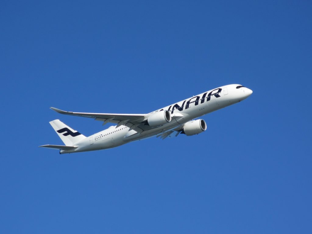 a white airplane flying in the sky