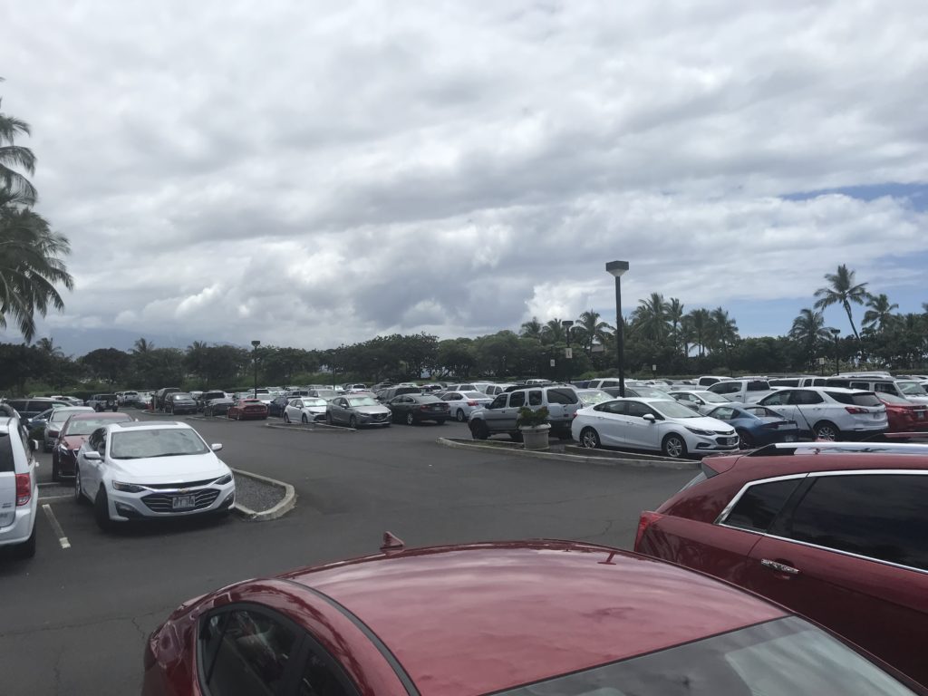 a parking lot with cars and trees