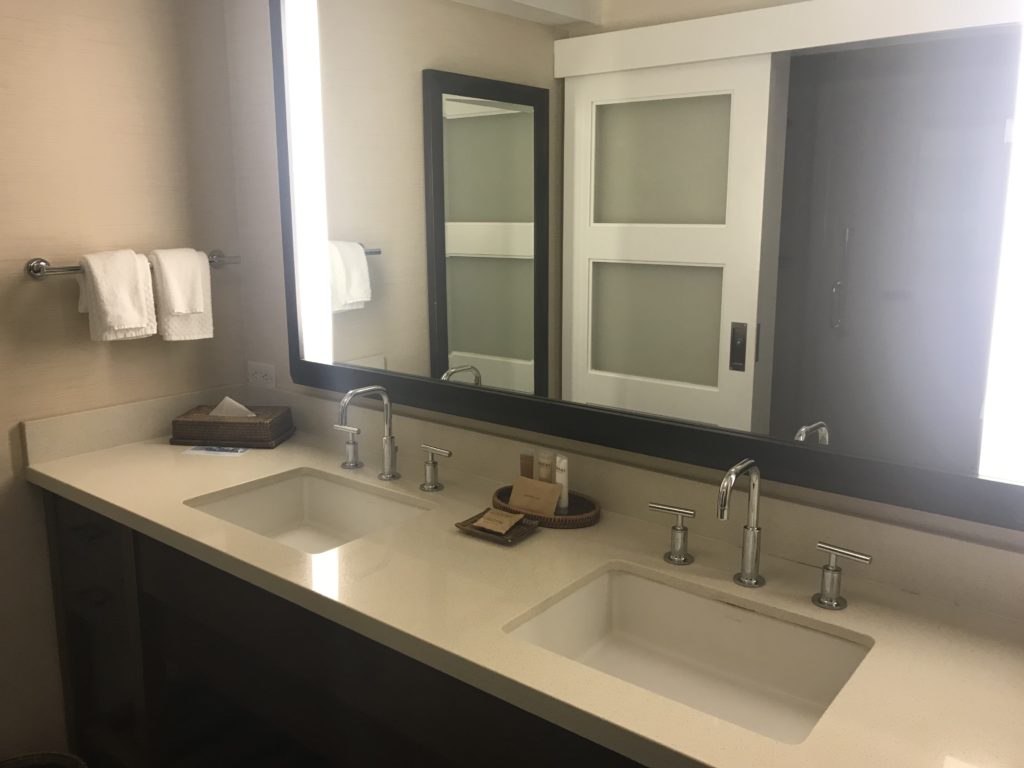 a bathroom with double sink and mirror